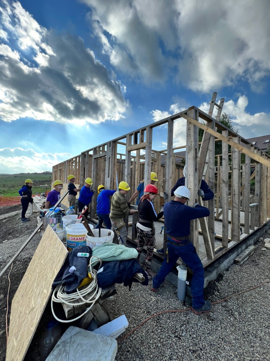 GB volunteers raise the wall on the first Global builders trip to Romania in October 2022