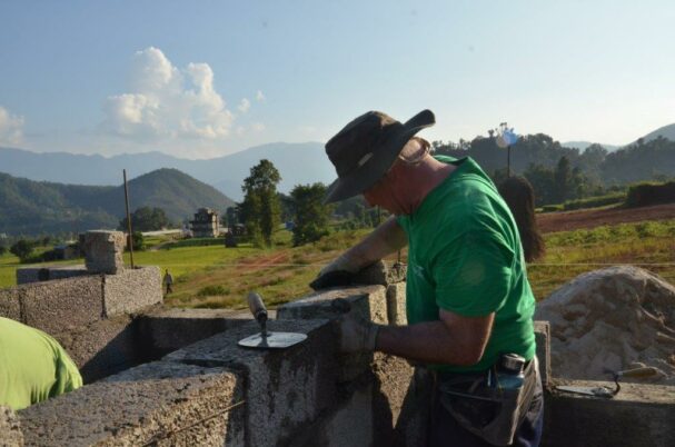 Nepal GB volunteer laying brick