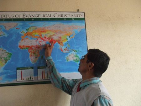 Barnabas pointing out Nepal on the world map