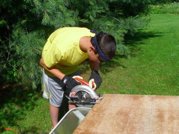 Participant cutting wood