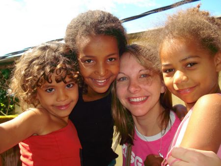 ACTION missionary from North Carolina with girls she ministers to in Brazil 